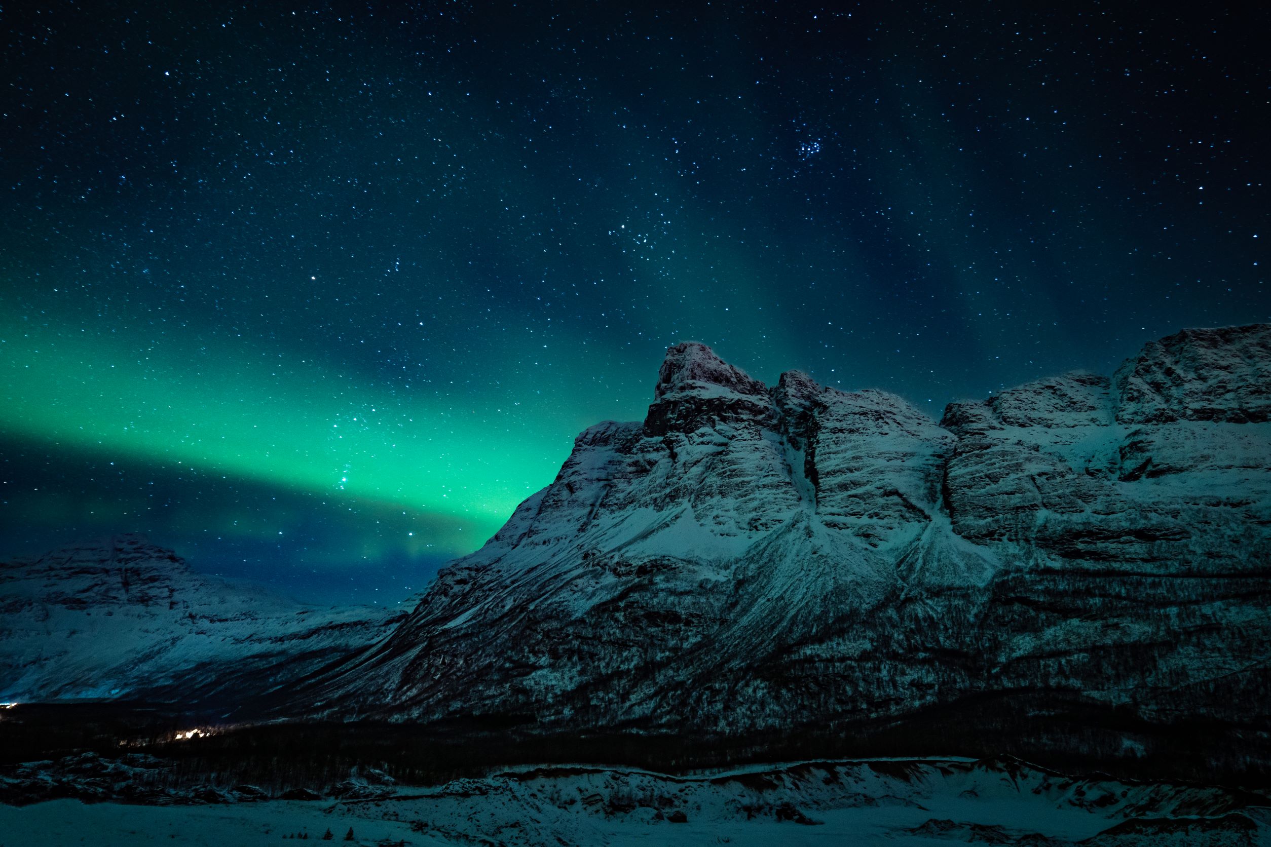 Northern lights above a mountain peak