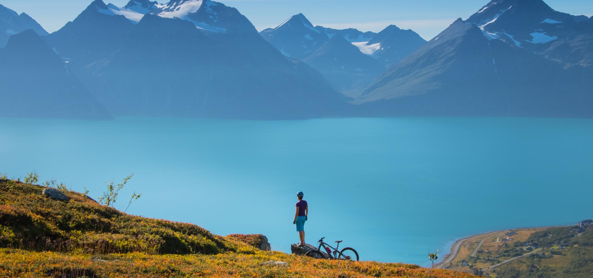 A biker enjoying the view of the Lyngenfjord and the Lyngen Alps