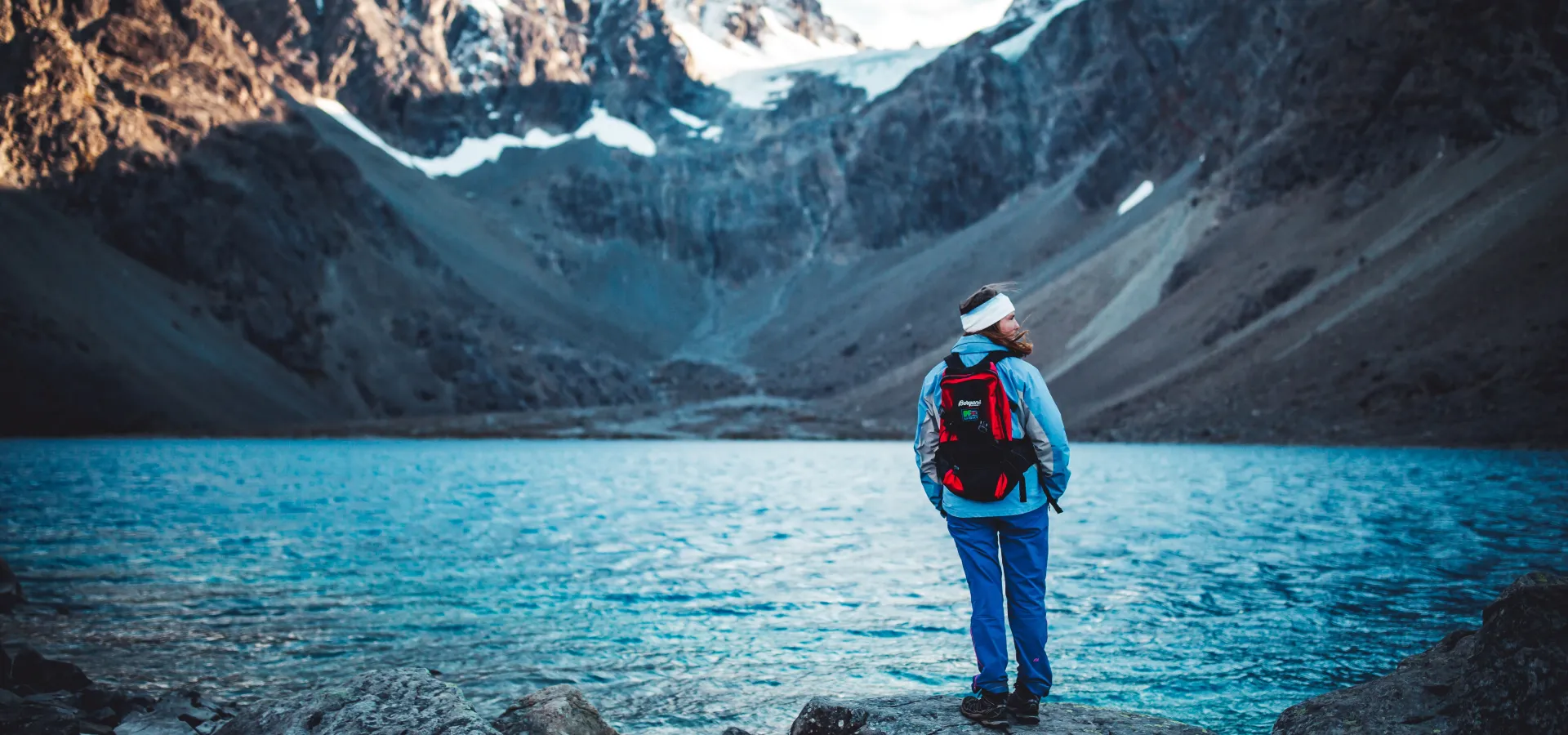 Woman looking at the blue ice lake