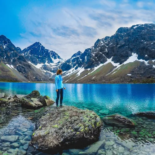 Standing by the Blue lake, enjoying the view of the lake and the Lyngen Alps