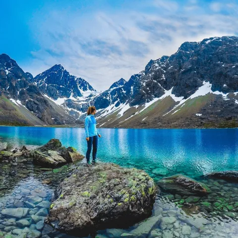 Standing by the Blåisvatnet and looking at the lake and the snowcapped Lyngen Alps in the background