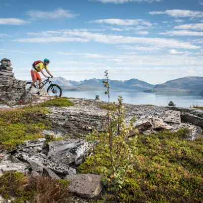 Mountain biker, fjord and mountains in the background
