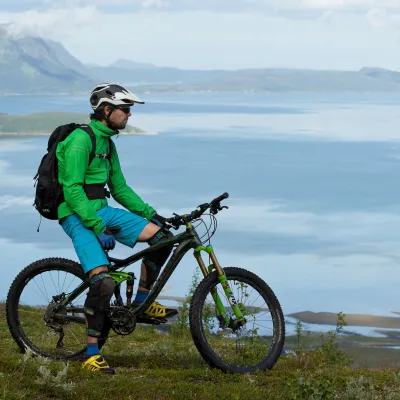 a mountain biker enjoying the fjord view