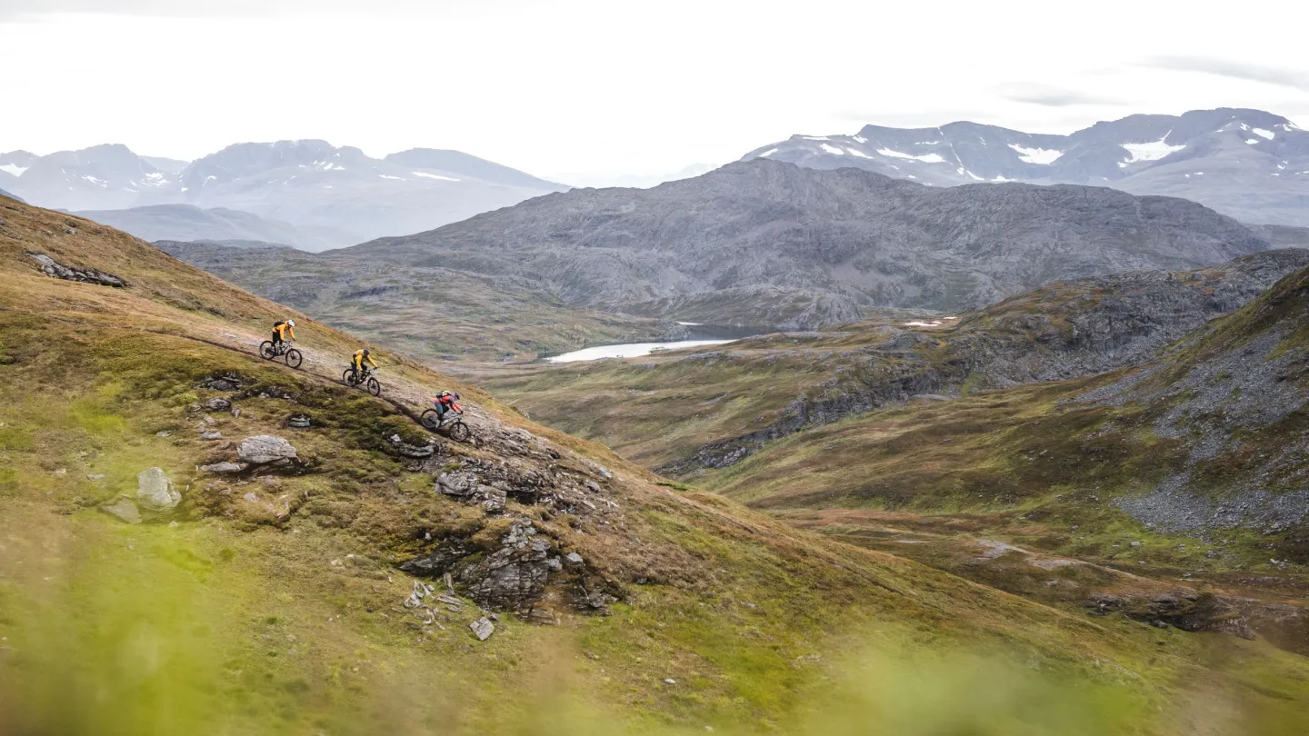 3 bikers on a trail in the mountains, autumn colours